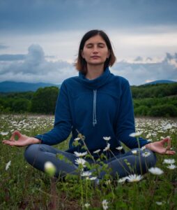 a-young-woman-doing-yoga-in-the-field-2023-11-27-05-25-45-utc